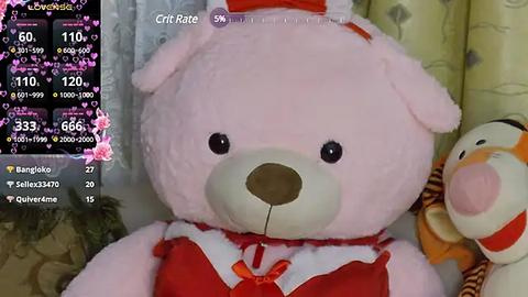 Media: A close-up video of a pink teddy bear in a red Santa outfit, with a purple and yellow background.