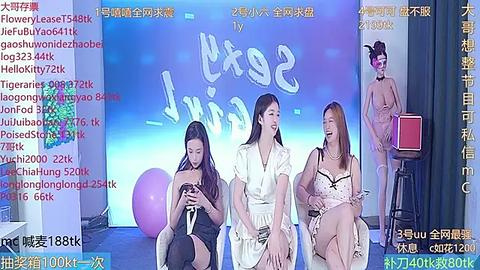 Media: A video of four young women in a studio, each wearing different dresses, seated on stools in front of a blue backdrop with a white \"Life\" sign.