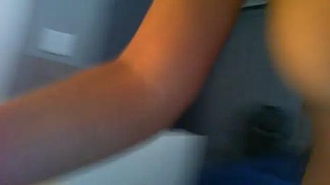 Media: A blurred video shows a person's arm and leg, suggesting they are bending, in a dimly lit room with a white wall and a dark object on the floor.