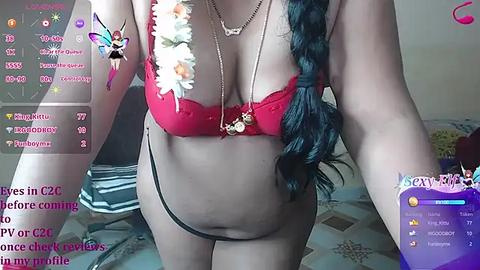 Media: Video of a light-skinned woman with long black braided hair wearing a red lace bra and black thong, surrounded by virtual reality overlays with chat messages and notifications.