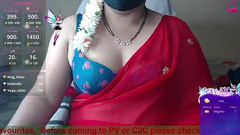 Media: Video of a woman wearing a blue bra with red flowers, a red sari, and a black mask, with a digital overlay showing \"PvP or C2C please check\" in red text.