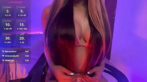 Media: Video of a slender woman with long, straight brown hair, wearing a revealing, low-cut, pink bra, holding her breasts, against a purple-lit background.