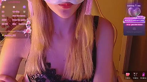 Media: A video of a blonde woman in a black lace bra, wearing a white mask, with a purple light background. Text overlays with social media links and emojis.