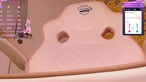 Media: Video of a VR headset with a pink, heart-shaped foam cushion featuring two small holes. The background shows a pink and beige room with a whiteboard displaying numbers.