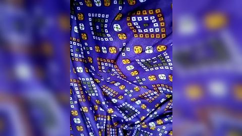 Media: Video of a person wearing a vibrant purple outfit adorned with a pattern of yellow and white rectangular shapes, creating a visually striking and modern aesthetic. The background is a blurred purple hue, enhancing the focal subject's bold, geometric design.