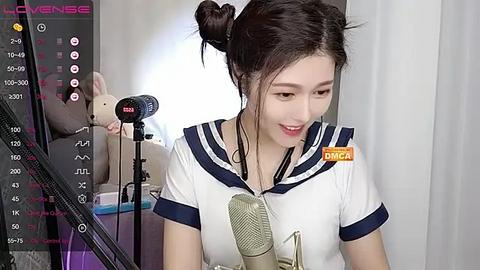 Media: Video of an East Asian woman with fair skin, black hair in a bun, wearing a white sailor uniform with navy blue trim, speaking into a microphone, set in a dimly lit room with a \"Dairy\" label.