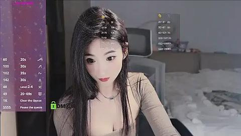 Media: A video of an Asian woman with long black hair, wearing a beige top, seated indoors, with a virtual reality headset displaying a menu.