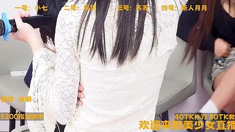 Media: A video shows a person with long black hair, wearing a white lace dress, being styled by a hairdresser, with text overlays in Chinese and English.