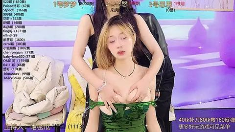 Media: Video of an Asian woman with light skin and blonde hair, topless, wearing a green dress, held by another woman in a black outfit, against a purple background with Chinese text.