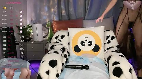 Media: A video of a person in a panda-themed costume lying on a bed, with a video game interface overlay showing health and ammo bars.