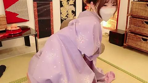 Media: Video of a woman in a light purple kimono, kneeling on tatami mats in a traditional Japanese room with wicker furniture, decorative screens, and a small table with food.